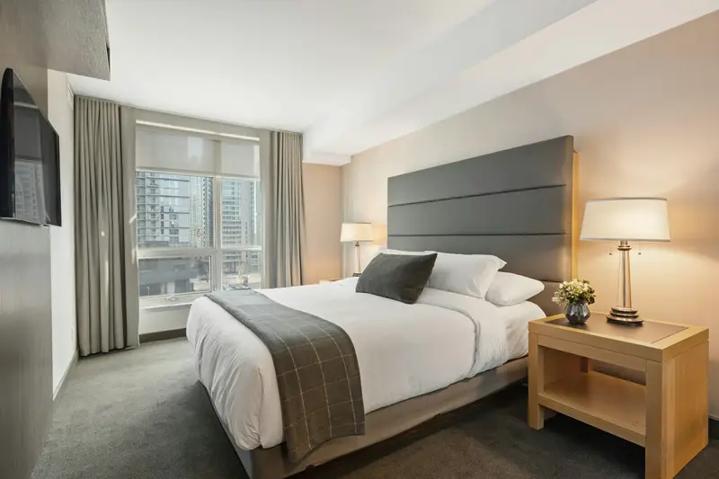 Freshly made bed with white linens